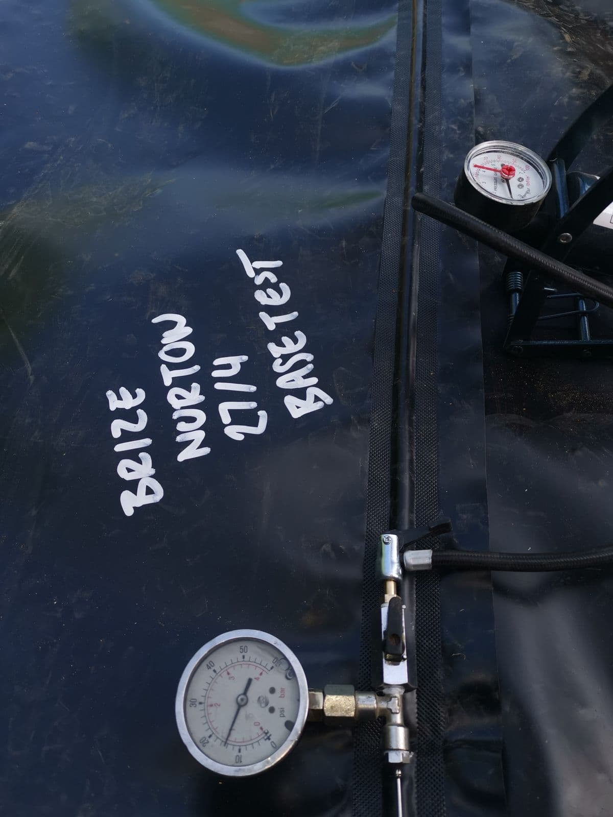 Base weld pressure test marked 'Brize Norton' on the membrane