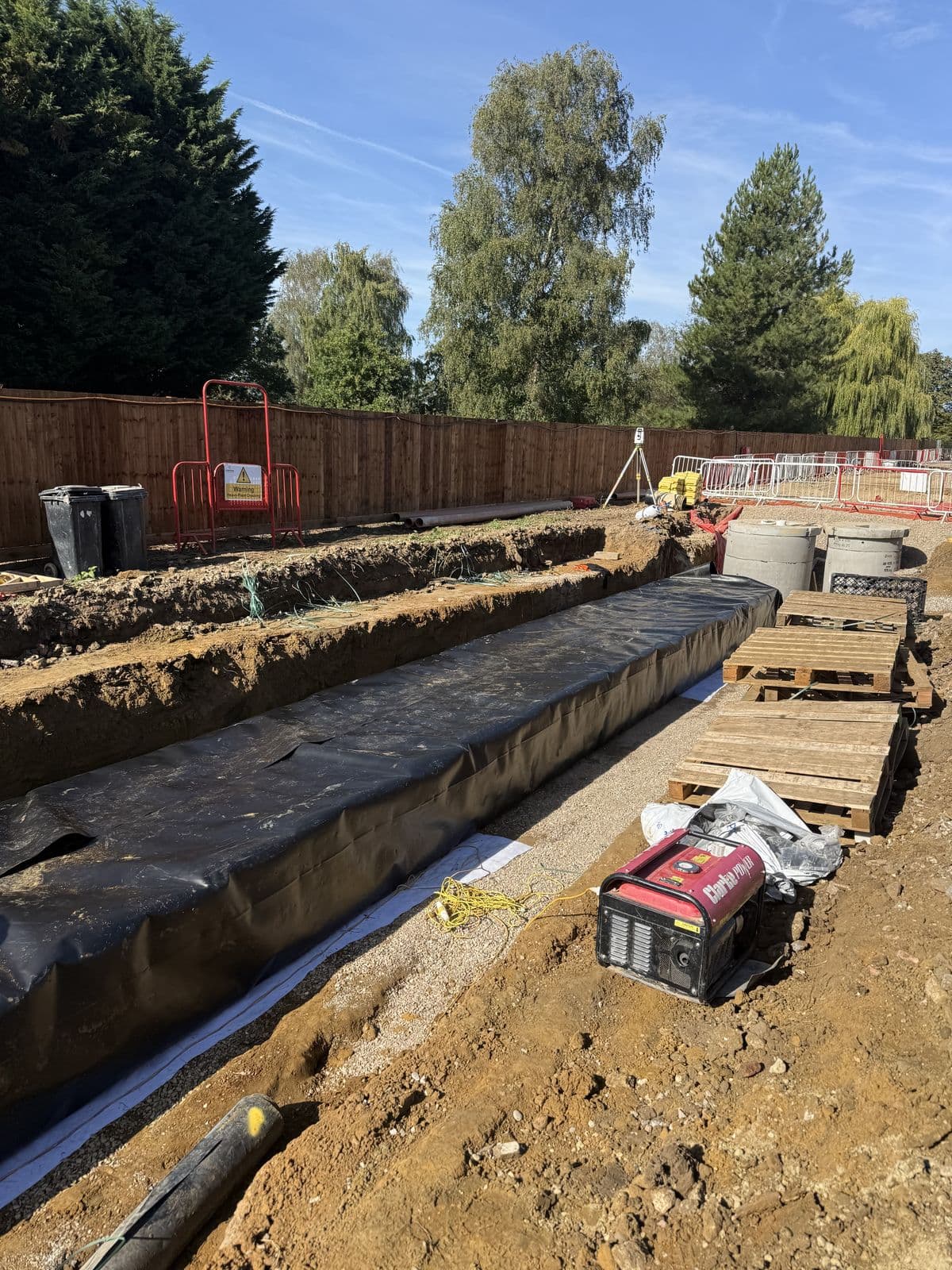 The wrapped Cottenham tank running the length of the trench, with welding kit alongside