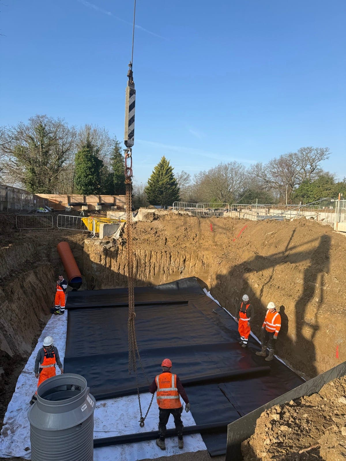 Membrane craned into the shored excavation at Enfield