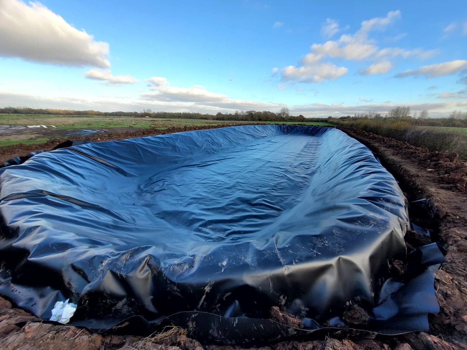 The 2,000m² slurry lagoon at Bodymoor Heath lined in LLDPE, anchored at the crest