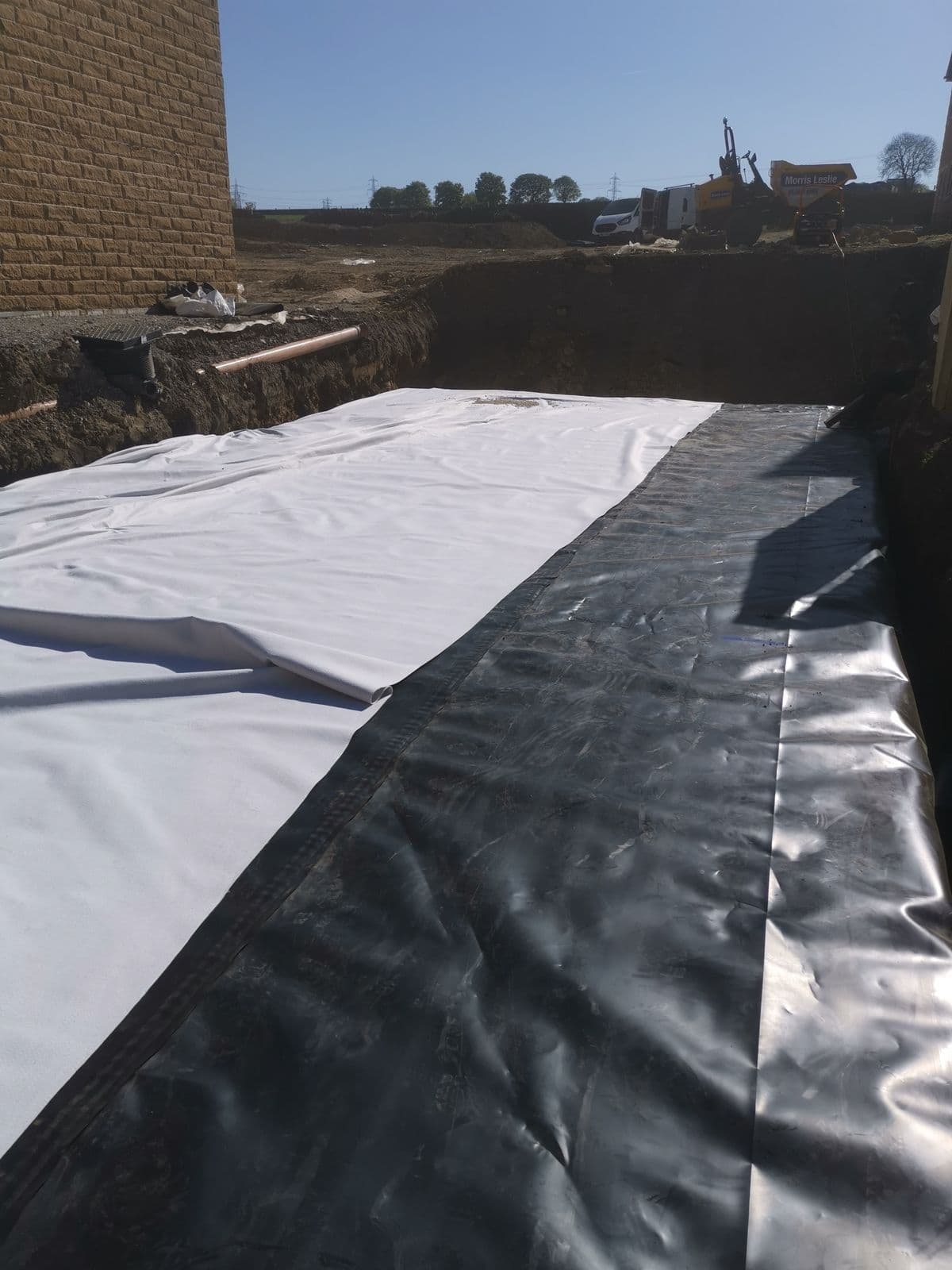 Geotextile and membrane being wrapped over the offline storage tank at Oxspring