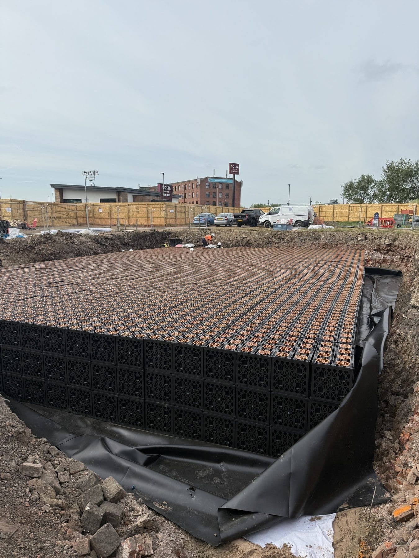A geocellular attenuation crate raft in a lined excavation