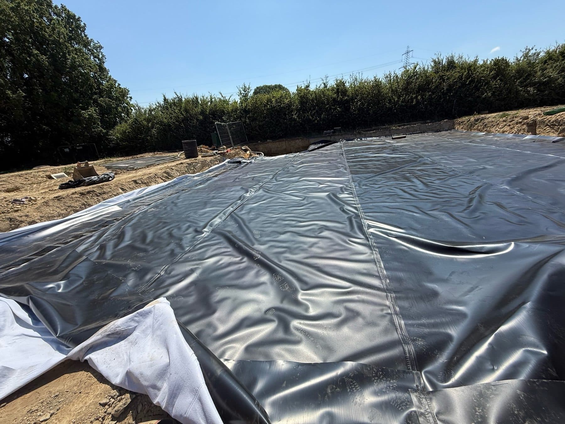 Geomembrane panels joined with dual-track hot wedge welded seams