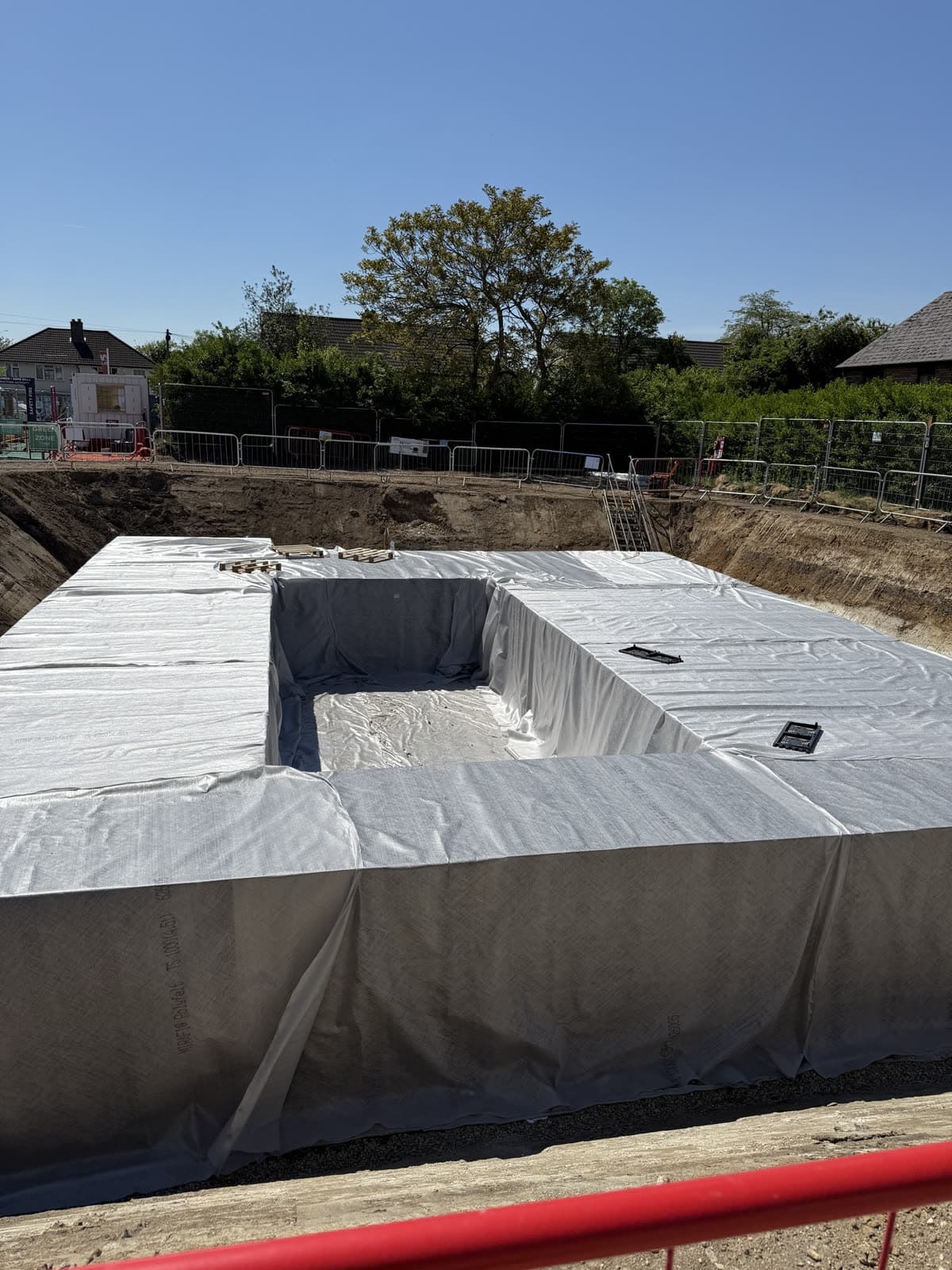 A geocellular crate block wrapped in geotextile in an open excavation
