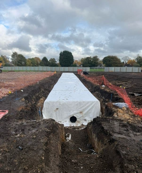 The wrapped Swanhurst School tank with its outlet fitting, ready for backfill